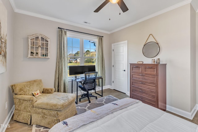 bedroom with ceiling fan, ornamental molding, and hardwood / wood-style flooring