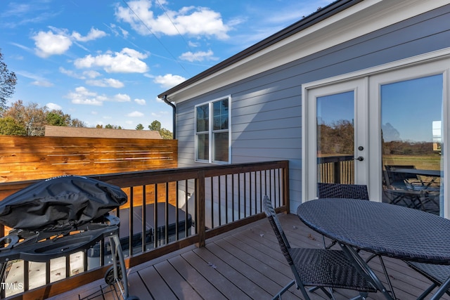 wooden deck with a grill