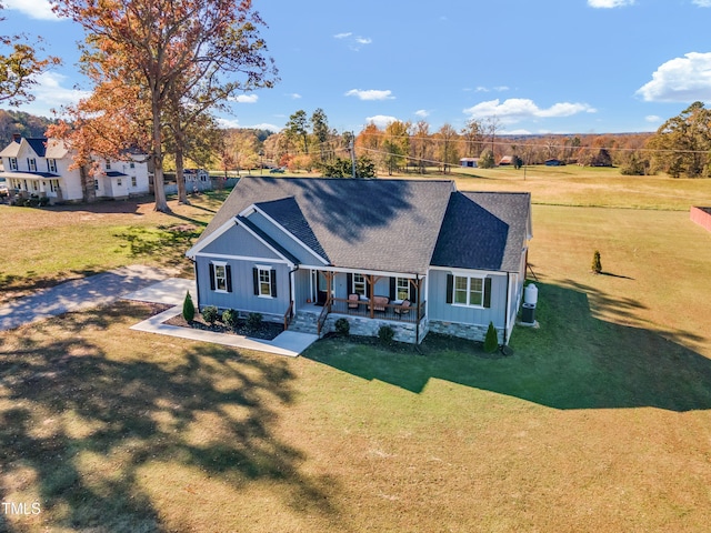 view of front of home with a front yard and covered porch