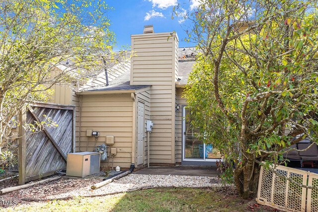 14 Stone Village Ct, Durham, NC 27704 - rear view of property with a chimney and a patio
