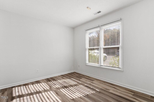 14 Stone Village Ct, Durham, NC 27704 - unfurnished room with wood finished floors and baseboards