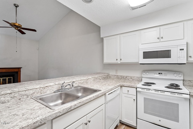 kitchen with sink, white cabinets, white appliances, lofted ceiling, and ceiling fan