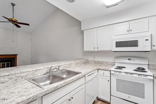 14 Stone Village Ct, Durham, NC 27704 - kitchen with white appliances, ceiling fan, a sink, light countertops, and lofted ceiling