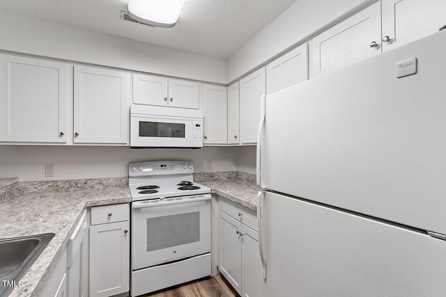 kitchen featuring white cabinetry, white appliances, a textured ceiling, and dark hardwood / wood-style floors