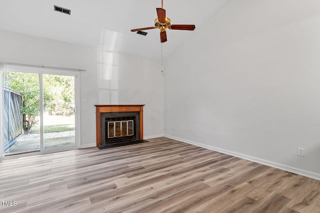 unfurnished living room with high vaulted ceiling, light wood-type flooring, and ceiling fan