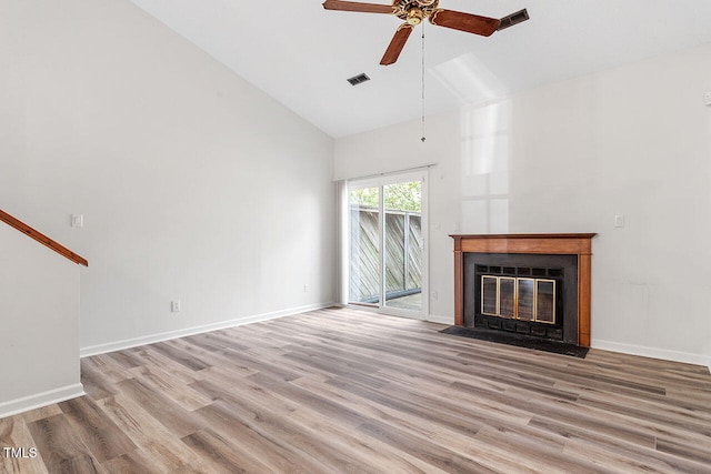 unfurnished living room with high vaulted ceiling, light wood-type flooring, and ceiling fan