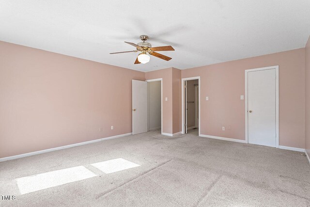 unfurnished room with light colored carpet and ceiling fan