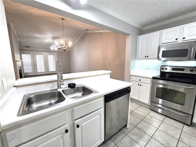 kitchen featuring appliances with stainless steel finishes, sink, white cabinets, light tile patterned floors, and a textured ceiling