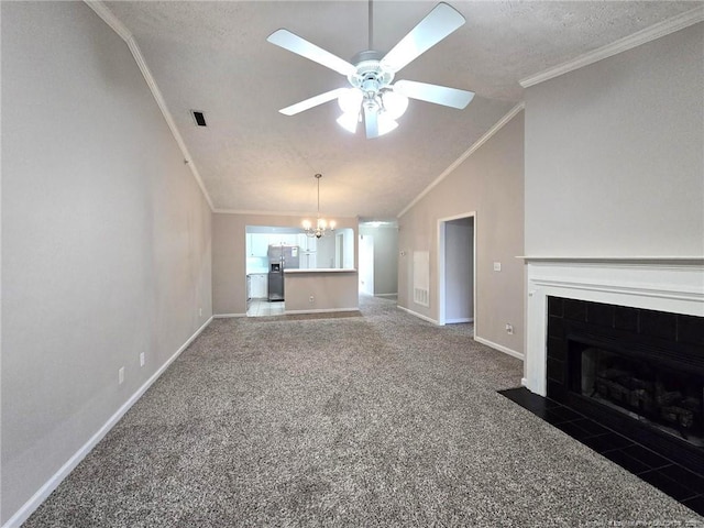 unfurnished living room with a fireplace, dark colored carpet, ornamental molding, ceiling fan with notable chandelier, and lofted ceiling