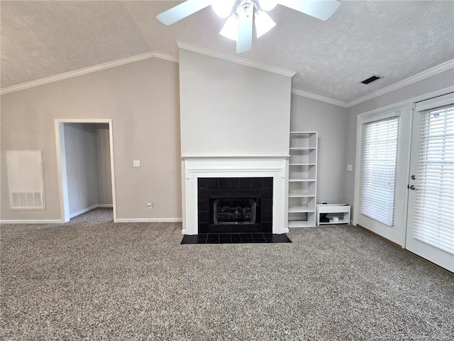 unfurnished living room with carpet, a textured ceiling, lofted ceiling, and ornamental molding