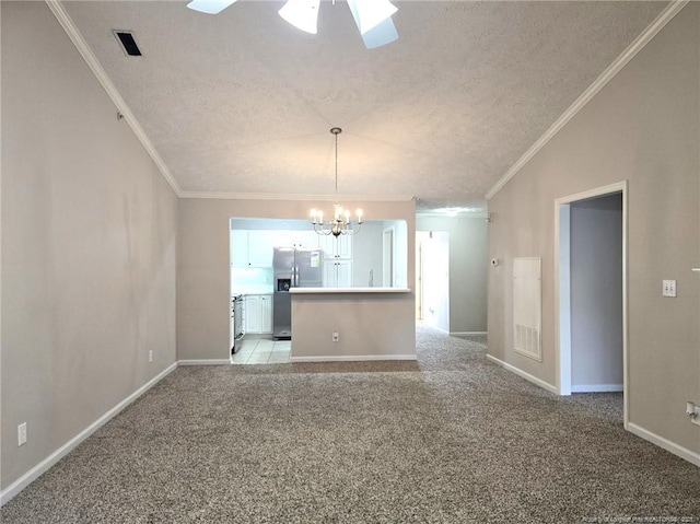 interior space featuring ceiling fan with notable chandelier, a textured ceiling, lofted ceiling, light carpet, and ornamental molding