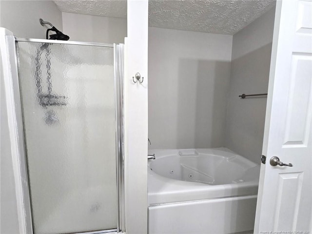 bathroom with independent shower and bath and a textured ceiling