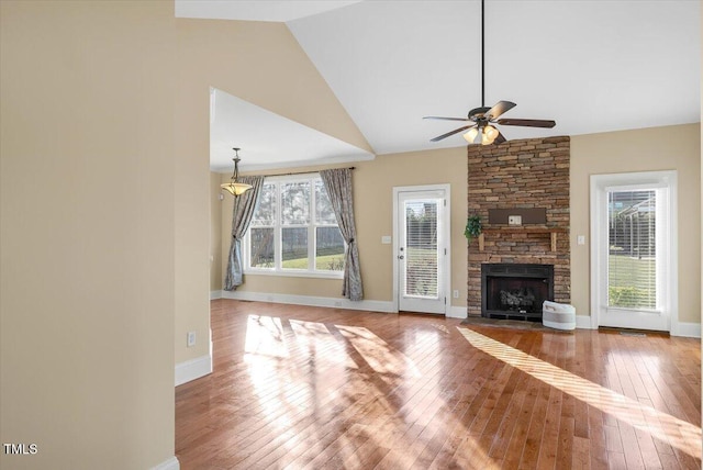 unfurnished living room featuring a fireplace, hardwood / wood-style flooring, ceiling fan, and lofted ceiling