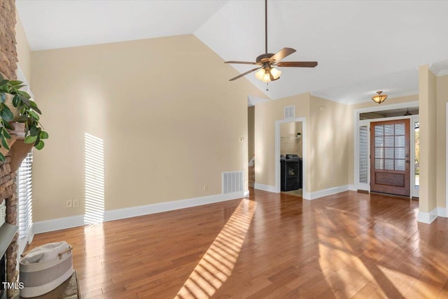 unfurnished living room featuring hardwood / wood-style floors, ceiling fan, and high vaulted ceiling