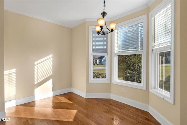 unfurnished dining area with light hardwood / wood-style flooring, a healthy amount of sunlight, and a notable chandelier