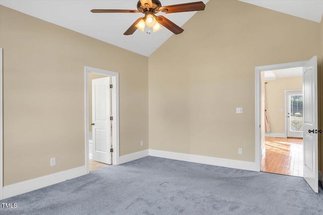 empty room with ceiling fan, light wood-type flooring, and high vaulted ceiling