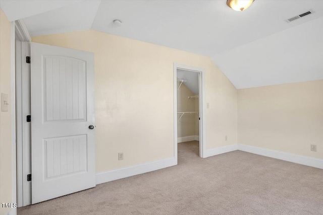 additional living space with light colored carpet and lofted ceiling