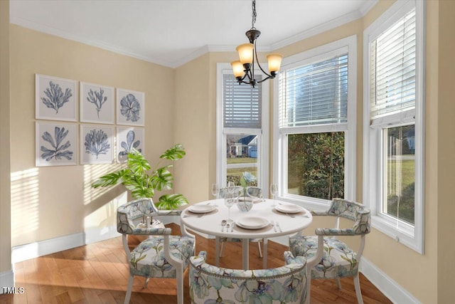 dining room with ornamental molding, light hardwood / wood-style floors, and a healthy amount of sunlight