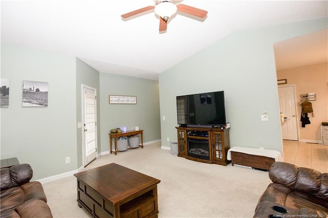 living room featuring light colored carpet, vaulted ceiling, and ceiling fan