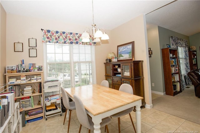 carpeted dining space with an inviting chandelier