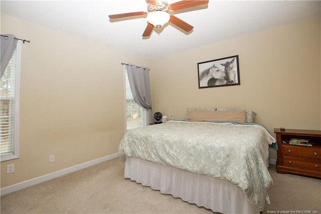 bedroom featuring ceiling fan and light colored carpet