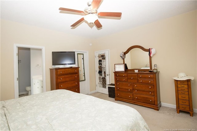 bedroom featuring ensuite bathroom, ceiling fan, and light carpet