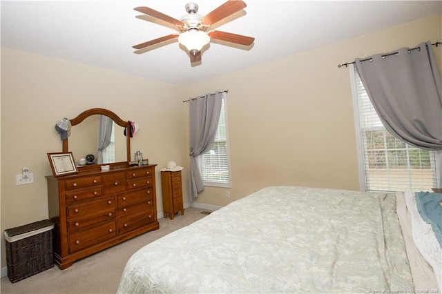 bedroom featuring light colored carpet and ceiling fan