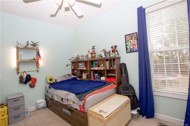 carpeted bedroom with multiple windows and ceiling fan