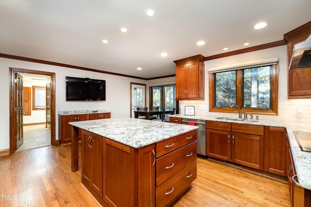 kitchen with dishwasher, sink, light wood-type flooring, and plenty of natural light