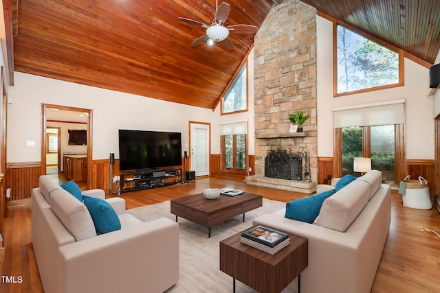 living room with high vaulted ceiling, light hardwood / wood-style floors, and plenty of natural light