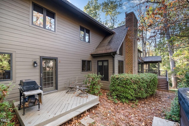 rear view of property featuring a deck