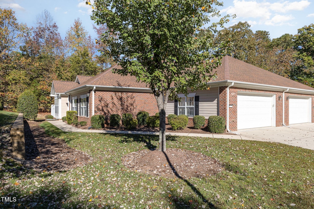 view of front facade with a front lawn and a garage