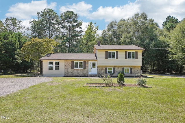1379 Juniper Lake Rd, West End, NC 27376 - split level home featuring a front lawn and brick siding