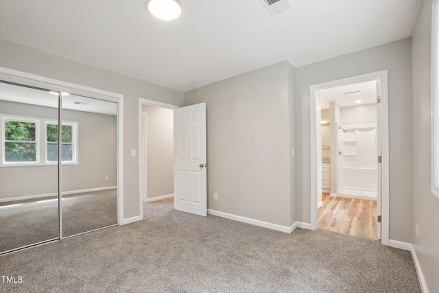 1379 Juniper Lake Rd, West End, NC 27376 - unfurnished bedroom featuring carpet flooring, a closet, and ensuite bath