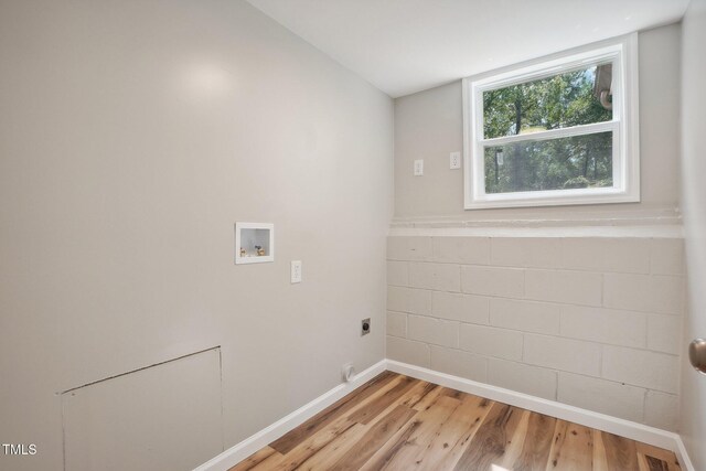 clothes washing area with light wood-type flooring, washer hookup, and hookup for an electric dryer