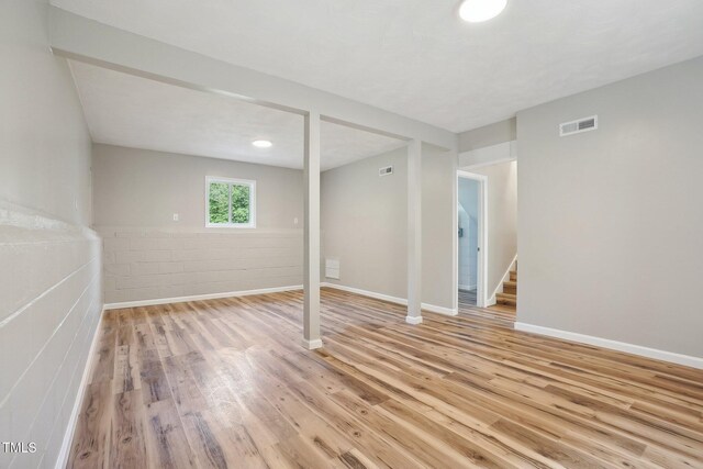 basement with light hardwood / wood-style flooring