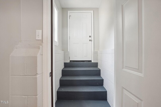 stairs with tile walls