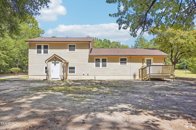 back of property with a wooden deck