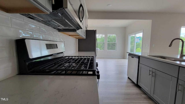 1071 Cherry Stem Rd, Haw River, NC 27258 - kitchen featuring appliances with stainless steel finishes, gray cabinets, tasteful backsplash, light wood finished floors, and light countertops