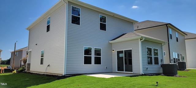 rear view of house featuring a yard, a patio, and cooling unit