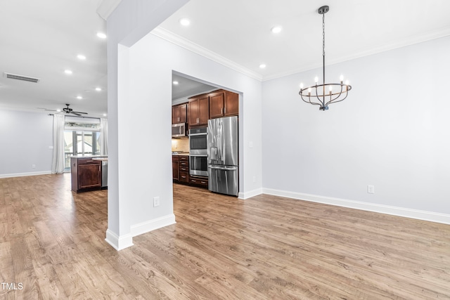 kitchen with pendant lighting, ceiling fan with notable chandelier, light hardwood / wood-style floors, and appliances with stainless steel finishes