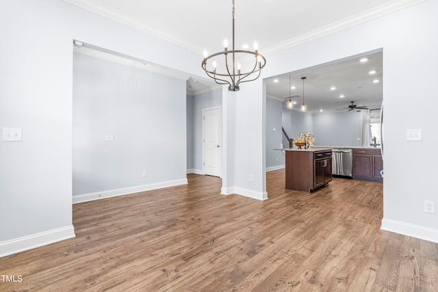 kitchen with ceiling fan with notable chandelier, crown molding, stainless steel dishwasher, decorative light fixtures, and a kitchen island