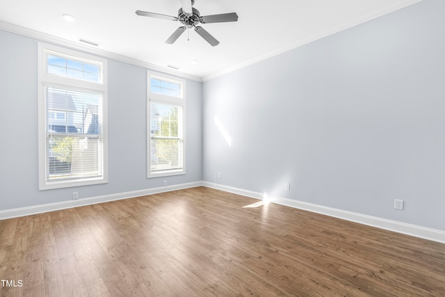 spare room featuring hardwood / wood-style flooring, ceiling fan, and ornamental molding