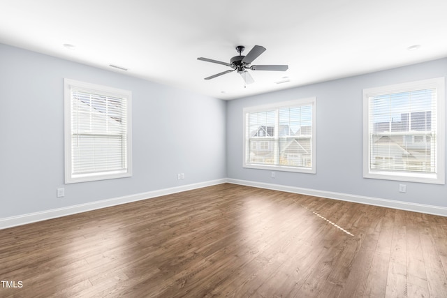 unfurnished room with dark hardwood / wood-style floors and ceiling fan