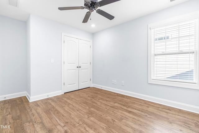 unfurnished bedroom with a closet, ceiling fan, and hardwood / wood-style floors