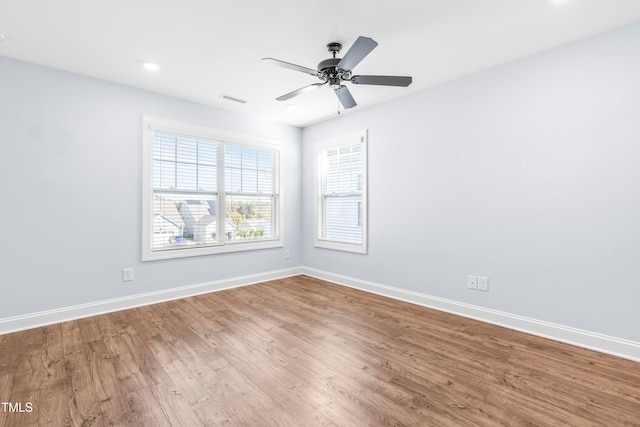 empty room with hardwood / wood-style flooring and ceiling fan