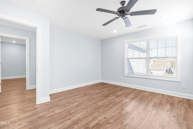 spare room featuring light wood-type flooring and ceiling fan