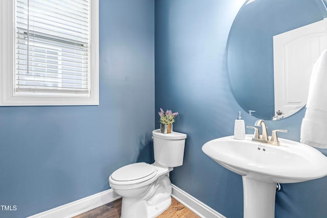 bathroom featuring hardwood / wood-style floors, toilet, and sink