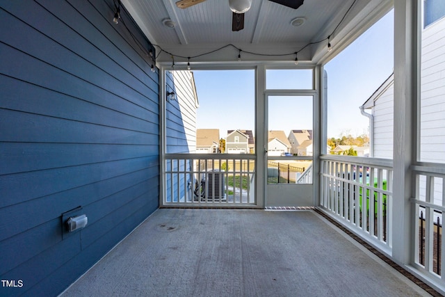 unfurnished sunroom featuring ceiling fan