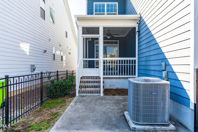 view of exterior entry with central AC and ceiling fan